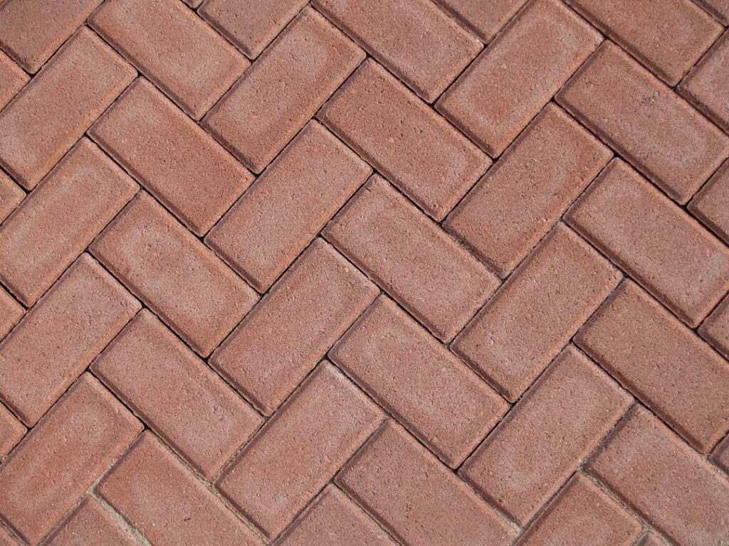 a close up of a red brick sidewalk