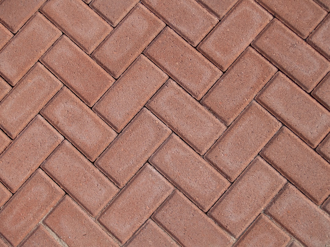 a close up of a red brick sidewalk