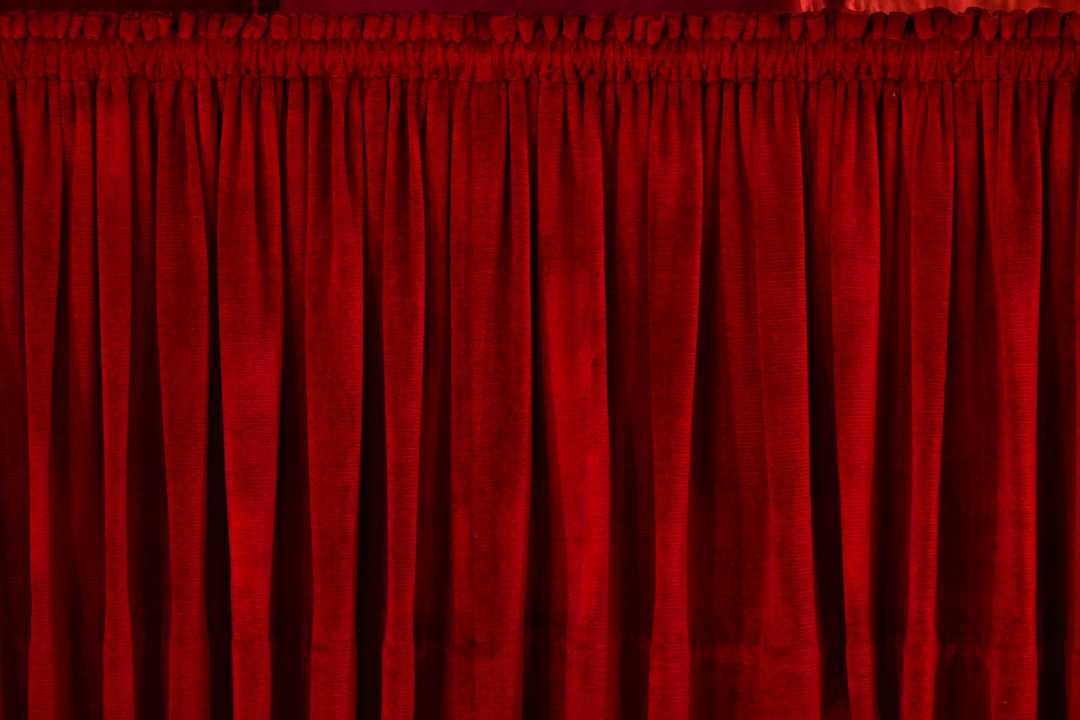 closeup photo of red rod pocket curtain