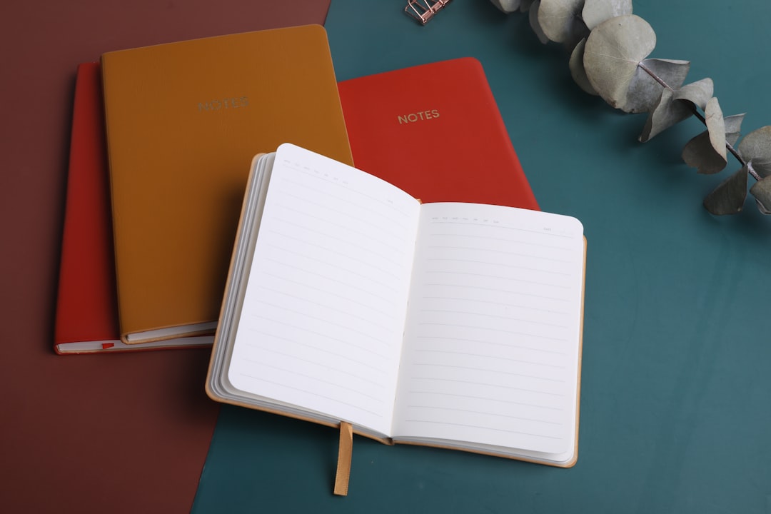three notebooks sitting next to each other on a table