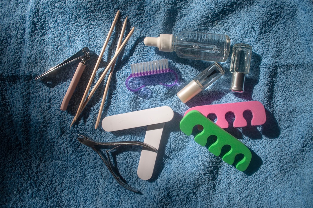 Manicure and pedicure tools on a blue towel.