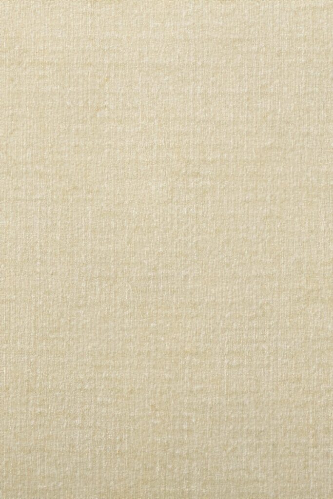 a close up of a beige fabric textured background