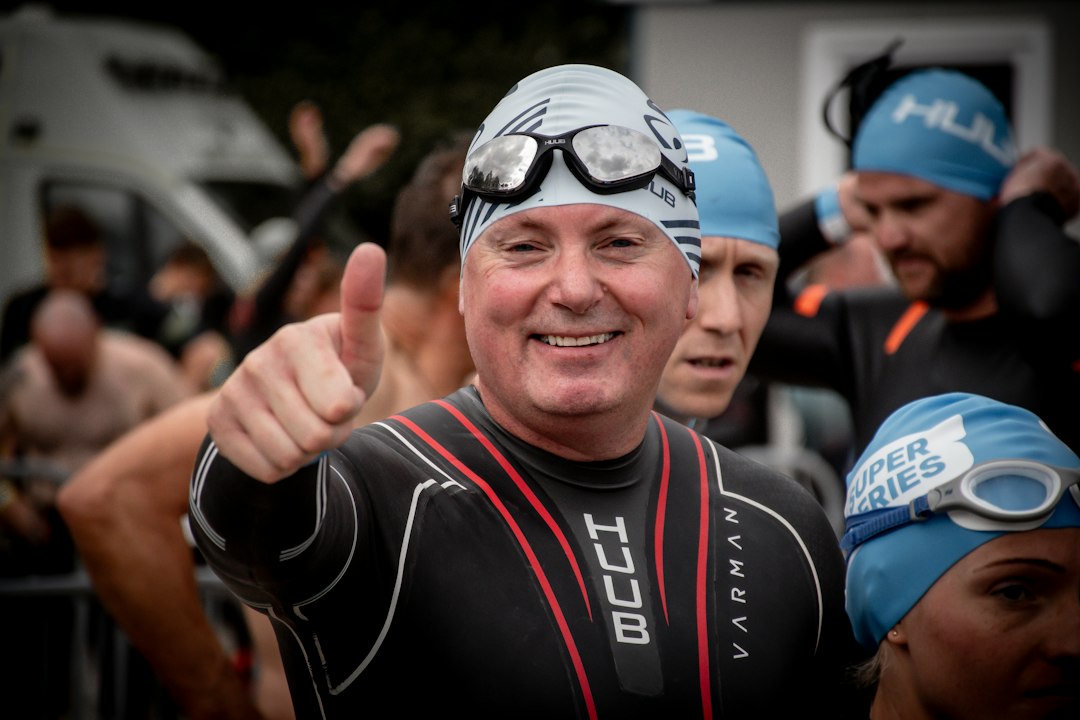 Man in wetsuit gives thumbs up